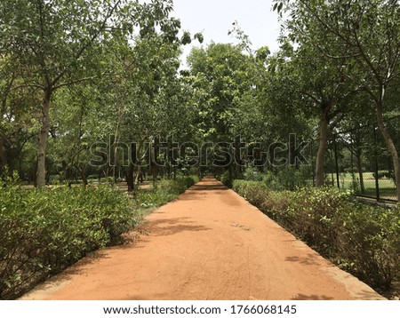 Running jogging track foot paths picture in garden with sand on floor.