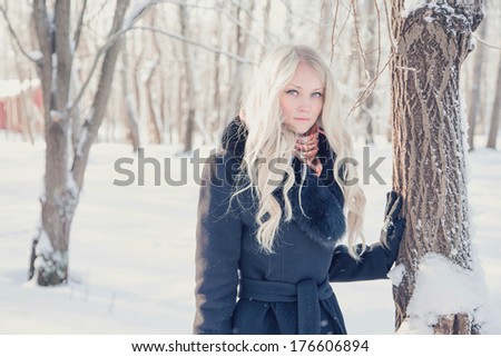 	Young blonde woman in winter