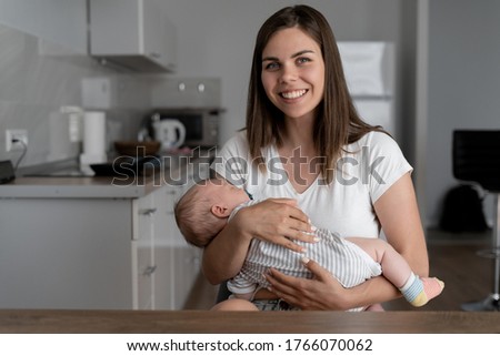 Portrait of happy excited young mother and child girl looking at camera, smiling mom with son making video call, family vlogs recording video blog
