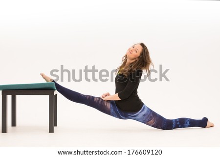girl doing stretching using chair