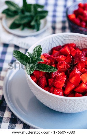 Fresh fruit salad - Strawberries with sugar and fresh mint in a bowl