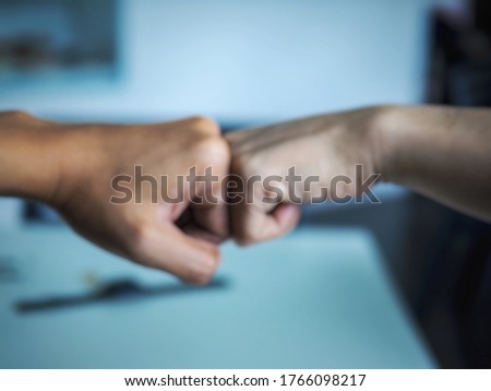 The pictures of blur Two hands helping another and coming togetheragreement ,teamwork.