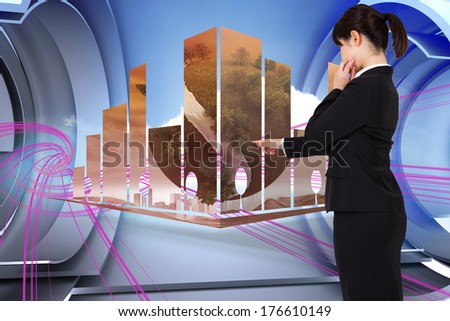 Businesswoman pointing against abstract pink design in futuristic structure