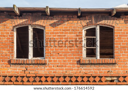 Old, abandoned and forgotten building of red brick - window