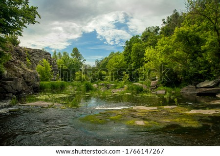 beautiful summer landscape nature photography canyon rocks green foliage and shallow river stream scenery environment space in July clear weather day time