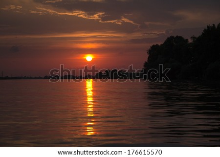 Beautiful sunset in Sulina harbor, Danube Delta, Romania. Image has a pleasant grain texture visible on its maximum size
