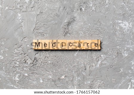 medicare word written on wood block. medicare text on table, concept.