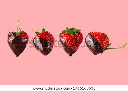 Ripe red strawberries with melted dark chocolate flows. Cooking a healthy dessert. On a pink background. Royalty-Free Stock Photo #1766163635
