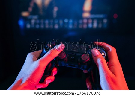 Close up female hands holding gamepad and playing videogames