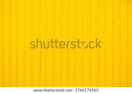 Yellow metal tile fence background. Fence from corrugated board. Yellow slate background. Yellow zinc metal sheet texture. Steel panel of the enclosing wall. Royalty-Free Stock Photo #1766174363