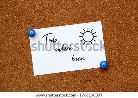 white note on cork board with message Everything will work out
