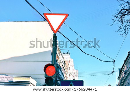 road sign: give way, against the blue sky 