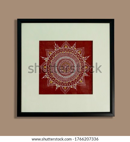 Beautiful white and red mandala painting with nice frame on gray background 