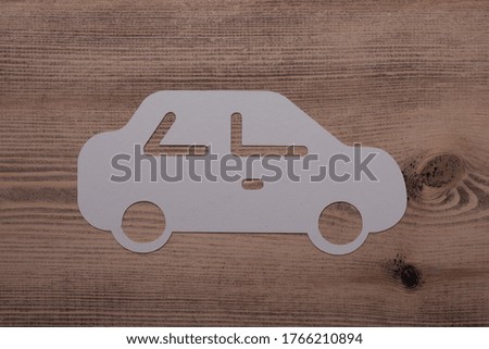 The papercut of a car on a wooden table