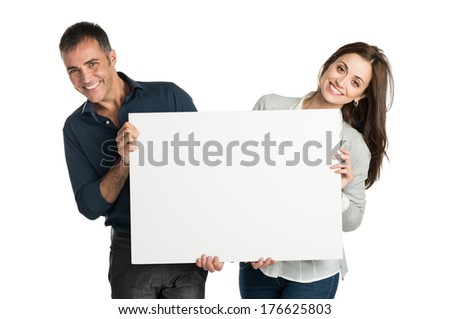 Mature Couple Looking At Camera With Sign Isolated On White Background