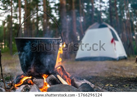 camping in the woods. cooking over an open fire. summer camping in nature. bonfire close-up