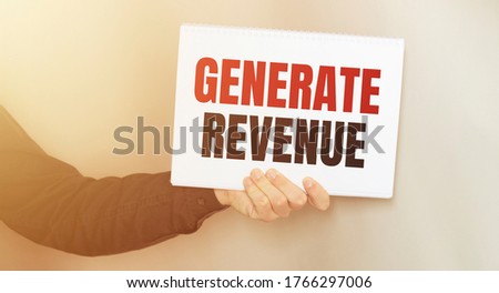 Businessman putting a card with text GENERATE REVENUE. business concept