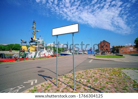 Empty road sign in the sea harbor. Blank  mockup  in city background port