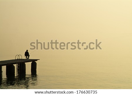 Anglers in the morning on Lake Garda Royalty-Free Stock Photo #176630735