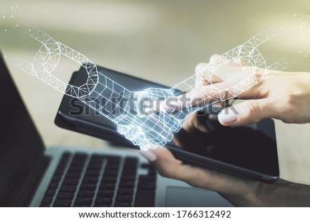 Creative abstract block chain technology sketch with handshake and hand working with a digital tablet on background, future technology and blockchain concept. Double exposure
