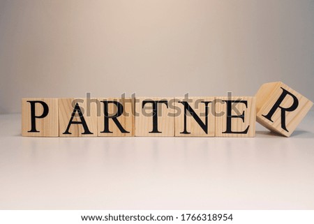 Partners word written on wood block. Partners text on wooden table for your desing, concept.