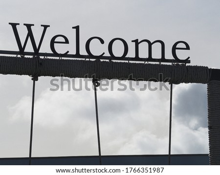 Welcome sign with cloudy backdrop