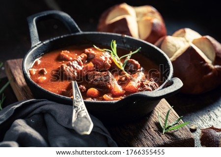 Tasty goulash served with fresh hot buns Royalty-Free Stock Photo #1766355455