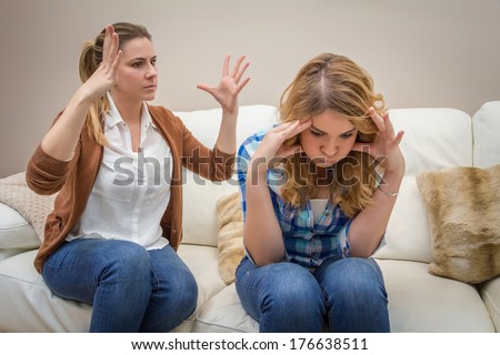 Furious young mother in a discussion with her teenage daughter. Problems between generations concept Royalty-Free Stock Photo #176638511