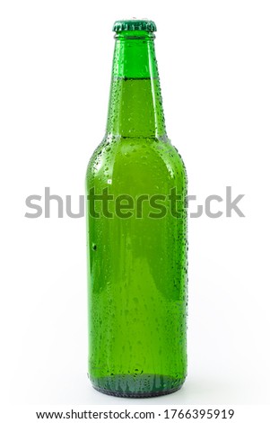 Cold refreshment and alcoholic beverages concept with picture of wet generic green bottle of beer without branding covered in water droplets isolated on white background with clipping path cutout