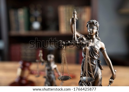 Lawyers office concept. Statue of justice, judges gavel, book background.