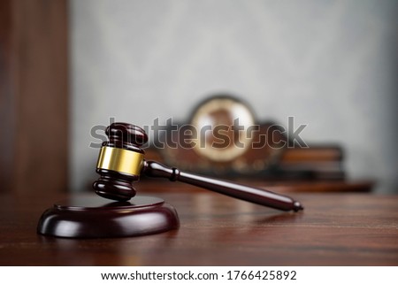 Lawyers office concept. Statue of justice, judges gavel, book background.