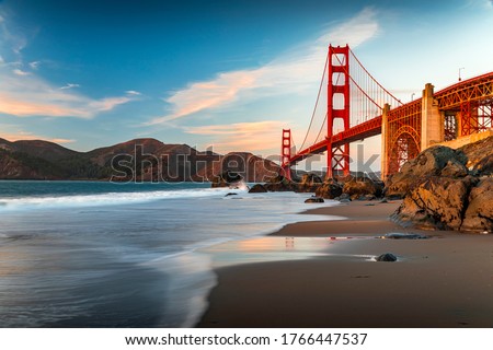 Famous Golden Gate Bridge view from the hidden and secluded rocky Marshall's Beach at sunset in San Francisco, California Royalty-Free Stock Photo #1766447537