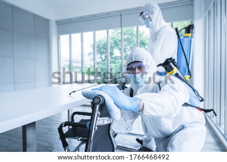 Specialist man in virus protective suite and mask spraying alcohol cleaning covid19 infected area, Virus disinfection concept Royalty-Free Stock Photo #1766468492