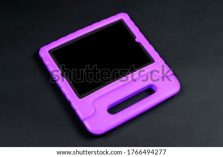 Tablet in a bright cover, designed for children - Isolated on black