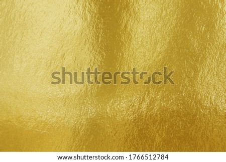 Gold foil texture background with highlights and uneven surface Royalty-Free Stock Photo #1766512784