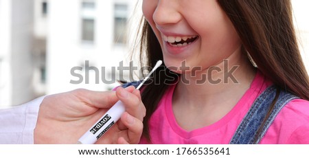 a girl suspected of being a healthy carrier of coronavirus makes a swab in her mouth Royalty-Free Stock Photo #1766535641