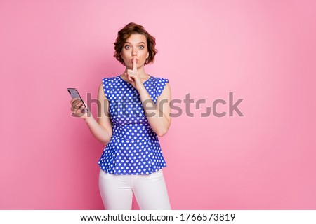 Portrait of her she nice attractive lovely creative mysterious brown-haired girl holding in hands cell showing shh sign sale app shop service isolated over pink pastel color background