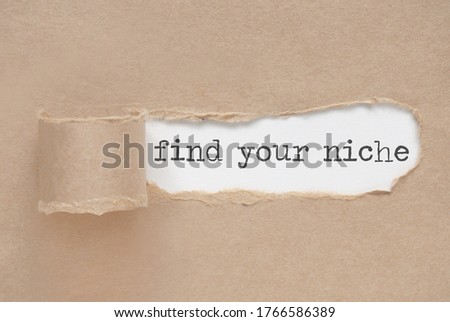 Torn paper revealing the words find your niche Royalty-Free Stock Photo #1766586389