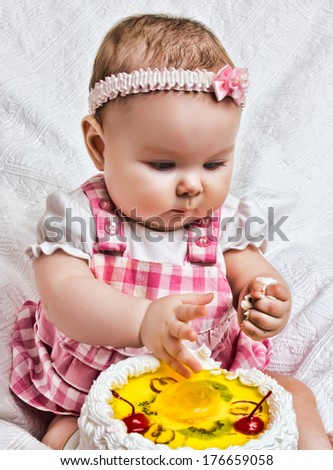 Little girl with a sweet cake in his hands