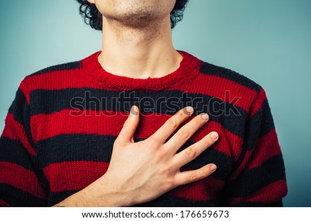 Young ethnic man is pledging allegience with his right hand raised Royalty-Free Stock Photo #176659673