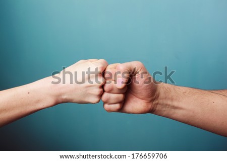 Young man and woman are fist bumping Royalty-Free Stock Photo #176659706