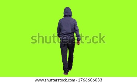 Back view of a hooded man walks on green screen background, Chroma key
