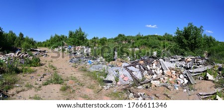 Panoramic photo of garbage and garbage outdoors under a blue sky.