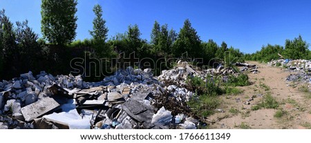 Panoramic photo of garbage and garbage outdoors under a blue sky.