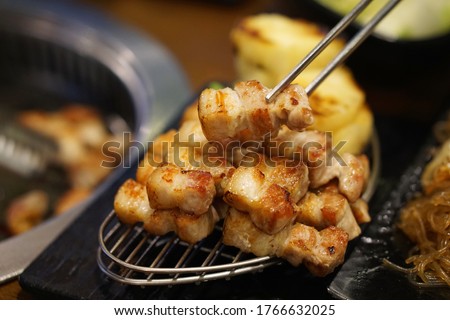 Samgyeopsal Gui - Grilled pork belly over hot charcoal stove, Korean BBQ style, The national street food of Korea. Royalty-Free Stock Photo #1766632025