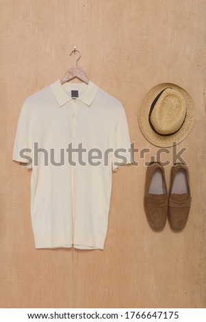 T-Shirts (Polo). With brown shoes and hat with on wooden background