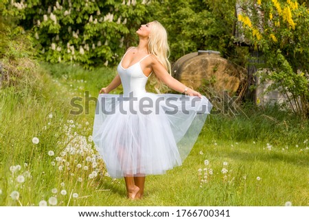 blonde model in white dress in nature