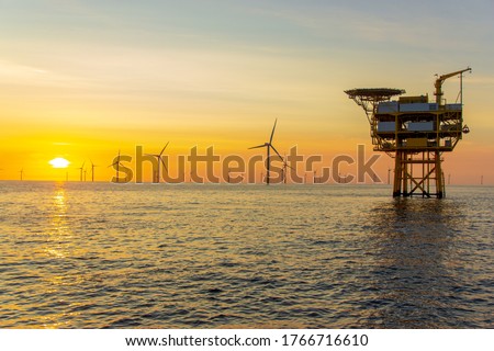 The beautiful sunset in the North Sea offshore wind farm Royalty-Free Stock Photo #1766716610
