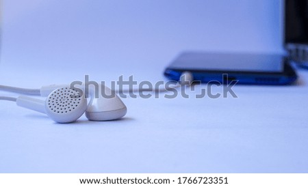 Close up earphones and mobile phones