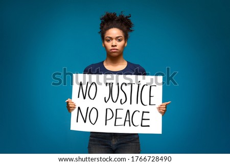 Support for equal rights of black people. African american girl holding placard No Justice No Peace